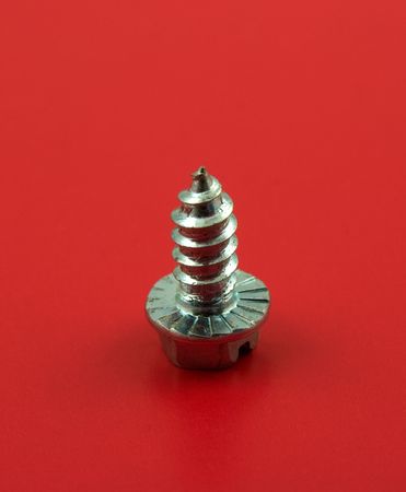 Screw isolated on redの写真素材