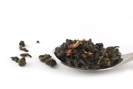 Spoon of dry green tea isolated on white.の写真素材