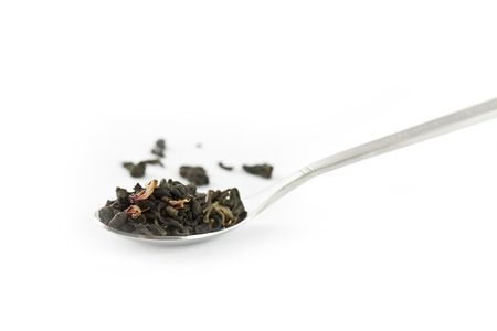 Spoon of dry green tea isolated on white.の写真素材