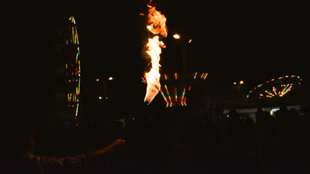 Holding A Fire Torch In Amusement Parkのeditorial素材