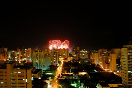 Fireworks behind the buildingsin the city .