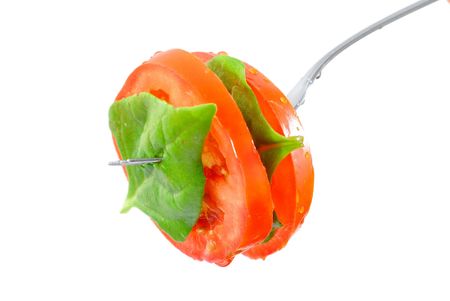 Spinach and Tomatoes slices jab in the fork . の写真素材