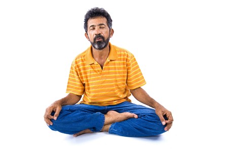 Adult Afro American meditating on white background .の写真素材