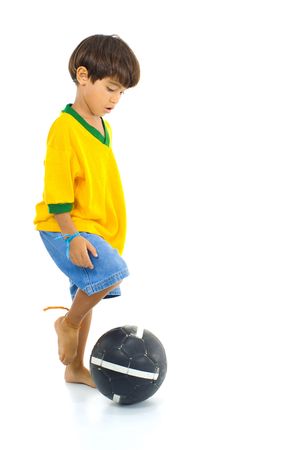 Young Child with Yellow Brazil T-shirt and a ball .の写真素材