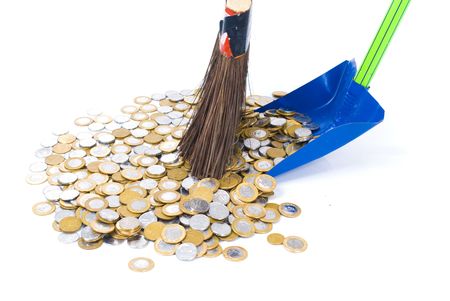 Coins on the floor being swept with a broom .の写真素材
