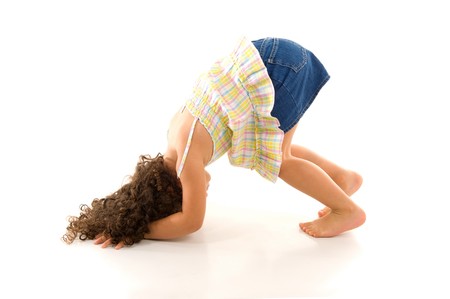 Girl doing cartwheel on a white background.の写真素材
