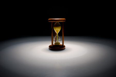 Vintage hourglass with yellow sand .