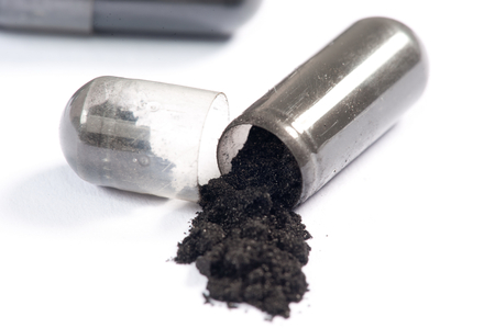 Pharmaceutical Black Pills or Drugs over white の写真素材