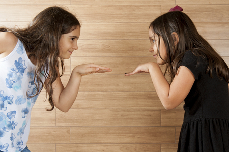 Two cute young girls playing indoor .の写真素材