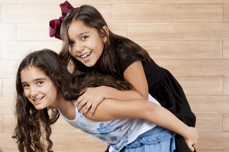 Two cute young girls playing indoor .の写真素材
