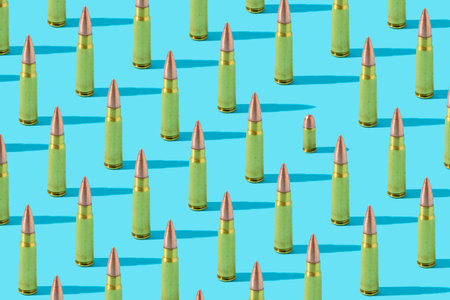 Pattern made of  golden bullets on blue background.