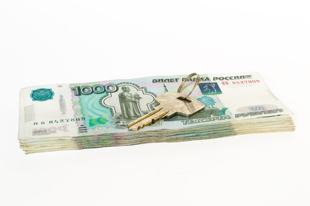 Key on heap of money. Concept of real estate buying, shoppingの写真素材