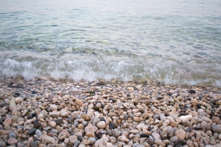 Gentle surf lapping against a pebble shoreの写真素材