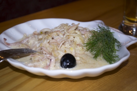 Seafood squid stew in creamy sauce with olive  Snack for beerの写真素材
