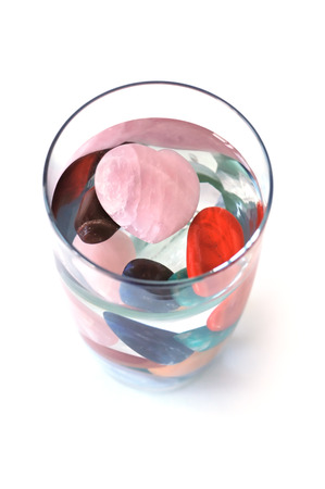 Crystal elixir  various kinds of crystal in full glass of water, making elixir, top viewの写真素材