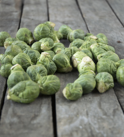 Defocused bunch of Brussels sprouts on wooden backgroundの写真素材