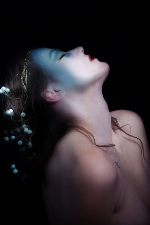 beautiful young woman styled as a nymph, studio shot