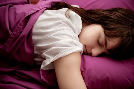 young woman sleeping indoor shotの写真素材