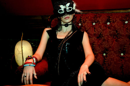 beautiful woman wearing mask on aparty