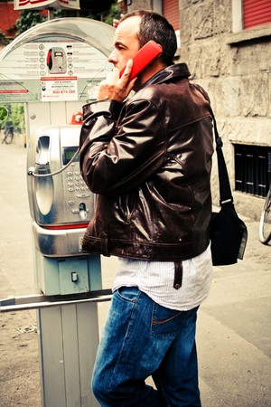 man use public phone on the streetの写真素材