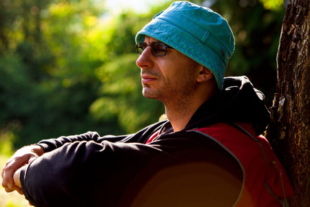 adult man resting in nature, spring day forestの写真素材