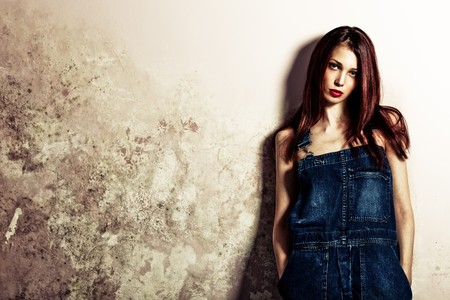 red hair woman in blue jeans studio shotの写真素材
