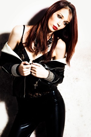 red hair woman in black leather, studio shotの写真素材