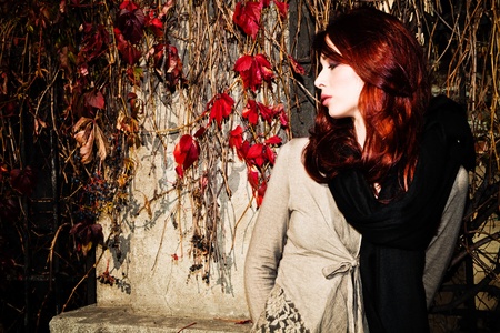 red hair young woman in sunny autumn afternoon outdoor shotの写真素材
