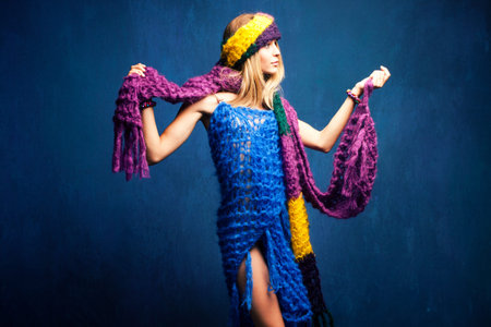 young woman in wool scarfs, studio shot