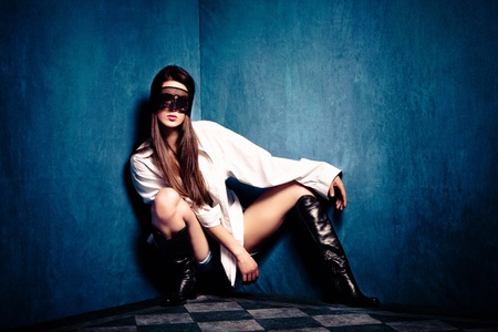 sensual woman in white shirt and lace over eyes in old grunge room, small amount of grain addedの写真素材