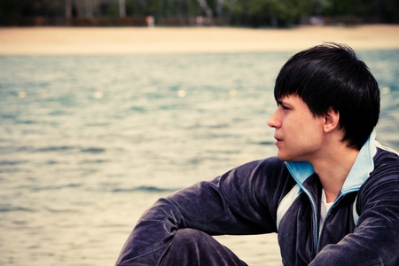 young man by the river portrait spring dayの写真素材