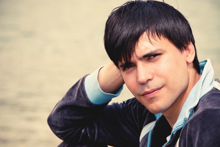 young man by the river portrait spring dayの写真素材