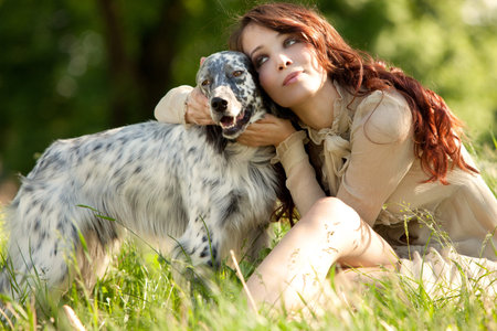 pretty woman and her dog enjoy in  summer day in grass