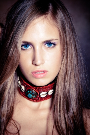 blue eyes young woman portrait wearing necklace made of shells studio shotの写真素材