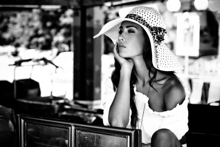 beautiful young woman portrait in black and white with elegant hat summer day outdoorの写真素材
