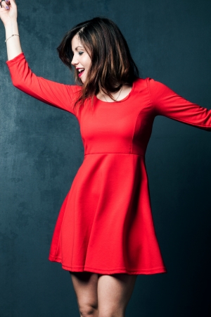 young woman dance in red short dressの写真素材