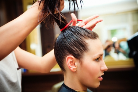 young woman at hairdresserの写真素材