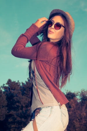 young hipster woman with hat and sunglasses outdoor shot の写真素材