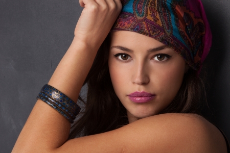 beautiful oriental look young woman portrait with scarf の写真素材