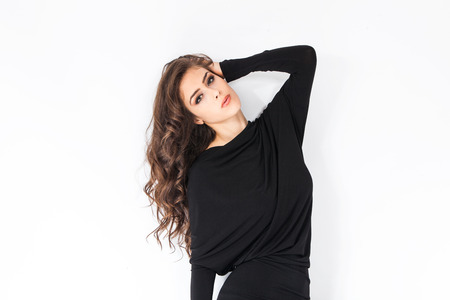 elegant young woman in black dress studio shotの写真素材