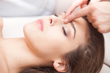 woman acupressure face massage closeupの写真素材