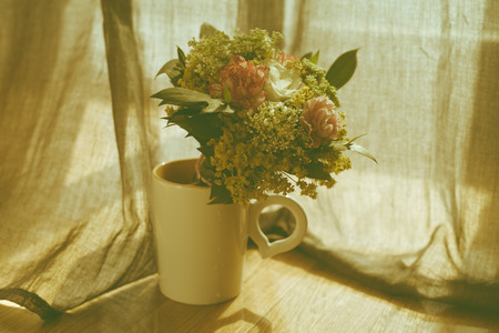 bouquet of flowers in a cup retro colorsの写真素材