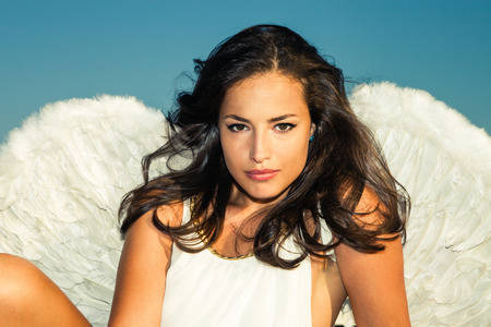 angel woman against blue skyの写真素材