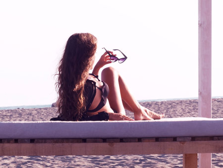 seating on the sand beach, sunset