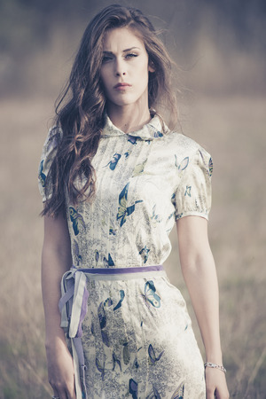 brunette woman in the field, fashion portraitの写真素材