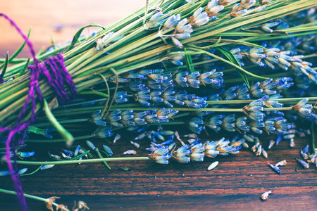 bouquet of dry lavender on natural wooden background, selective focus, closeupの写真素材