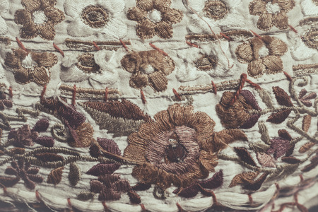 background embroidery on rough cotton canvas, retro colors, hand madeの写真素材