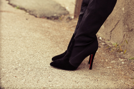 young woman in  high heels boots,  outdoor on street, closeupの写真素材