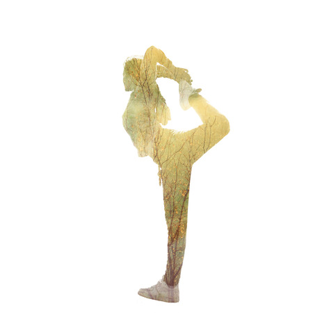 young woman in balance position, double exposure with tree photoの写真素材