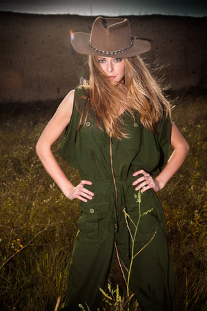 young blonde girl with cowboy hat outdoor in grass, summer dayの写真素材